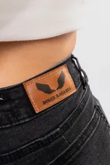 Pantalón de jean negro de tiro alto con corte oxford y botamanga acampanada.