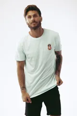 Remera celeste de corte clásico con cuello redondo y manga corta. Estampado pequeño en el pecho.