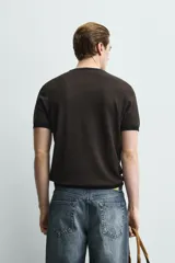Camiseta de punto de corte regular, confeccionada en una mezcla de viscosa. Presenta cuello redondo y mangas cortas con acabados en rib.
