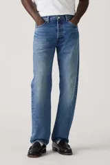 Jeans de corte recto y tiro mid-rise, color azul con lavado medio y efecto ligeramente desgastado, con cierre de botones.