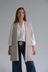 Chaleco largo abierto de tejido de punto, color visón, con bolsillos frontales aplicados y diseño sin mangas.