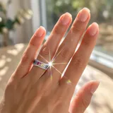 Anillo de plata 925 tipo medio sin fin, con diseño de circonias rectangulares en degradado multicolor y bordes pavé.