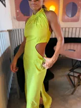 Vestido largo color lima con cuello halter, espalda descubierta, abertura lateral en la falda y recorte en la cintura.