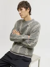 Sweater de punto con manga larga, cuello redondo y fit relajado. Presenta un diseño con textura acanalada y trenzas verticales, con puños y cuello acanalados.