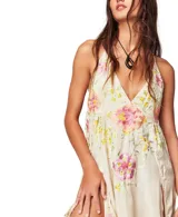 Top largo color beige de viscosa con escote en V, tiras ajustables en la espalda, tajos laterales con volados y bordados florales multicolor.