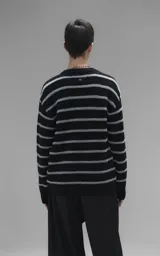 Sweater de cuello redondo con diseño de rayas horizontales en negro y gris. Presenta una textura suave y peluda, con terminaciones en punto rib en el cuello.