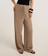 Pantalón wide leg color crudo, con cintura elástica ajustable con cordón y textura.