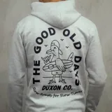 Canguro gris claro con capucha y cordones negros. Estampado en el pecho con texto en azul marino, dibujo de un fantasma y texto de la marca Duxon Jeans.