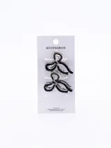 Set de dos pinzas para el pelo con forma de moño, color negro con borde transparente.