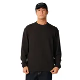 Remera Rip Curl de manga larga y textura tipo waffle, color negro, con cuello redondo y diseño de corte clásico.