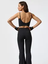 Top deportivo crop top negro con costuras visibles inspiradas en corsés victorianos, tirantes finos y espalda rebajada.