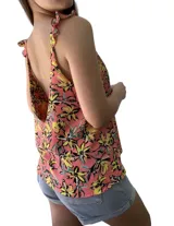 Blusa sin mangas color salmón con estampado de flores amarillas y negras.