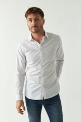 Camisa de hombre de corte slim fit, confeccionada en algodón con diseño de rayas verticales finas en tonos claros. Presenta cuello clásico, cierre frontal con botones y logo bordado en el pecho.