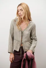 Chaqueta de textura arrugada en color verde sage, con mangas largas, escote en V y cierre frontal mediante tiras para anudar.