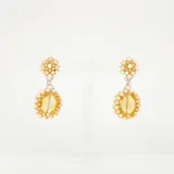 Aros colgantes con forma circular, tramados con cristales rosas y dorados.