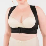 Top corrector de postura color piel, de alta tensión con bandas cruzadas en la espalda y broche delantero en bajo busto. Confeccionado con tela que contiene fibra LYCRA®.