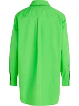 Camisa verde de popelín de algodón orgánico, corte oversize con hombros caídos, cuello inglés, bolsillo de parche en el pecho y logo bordado en la manga.