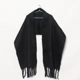 Mantón negro de lana con flecos en los extremos.