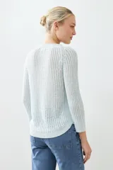 Sweater tejido de punto color rojo con cuello redondo y ruedo curvo.