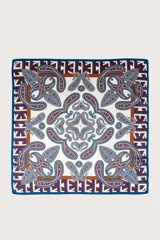 Pañuelo cuadrado de seda con estampado paisley y bordes geométricos en tonos azul, blanco y marrón.