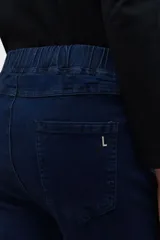 Jegging de jean elastizado color azul oscuro, con cintura alta elástica y bolsillos traseros.