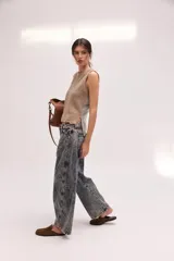 Pantalón jean de algodón con corte barrel y tiro bajo, de color azul, con bolsillos delanteros y traseros.