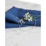 Anillo de plata 925 con diseño de corazón calado adornado con pequeñas zirconias brillantes.