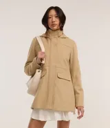 Campera alargada de Blue Steel confeccionada en polivelour, con cuello alto, capucha desmontable, cierre frontal oculto y bolsillos con solapa. Presenta un diseño minimalista y elegante con recortes delanteros.