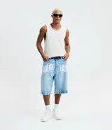 Bermuda baggy de jeans color celeste con lavado claro, corte holgado y diseño largo hasta las rodillas. Presenta una estampa grande con tipografía gótica en la parte delantera.