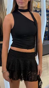 Top negro de un solo hombro con detalle de cuello tipo choker integrado y caída lateral, confeccionado en tejido elástico.