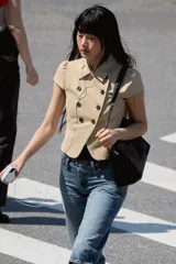 Chaqueta entallada color beige con cuello solapa, manga corta abullonada y doble botonadura frontal.