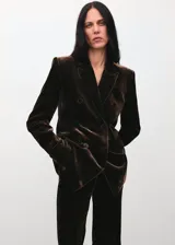 Pantalón de terciopelo marrón de tiro alto y estilo flare, con diseño largo y forro interior.