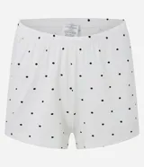 Conjunto de pijama compuesto por una musculosa de breteles finos ajustables con detalle de encaje negro en el escote y un short con cintura elástica. Ambas prendas presentan un estampado de lunares negros sobre fondo blanco.