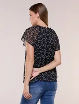 Blusa holgada de gasa negra con estampado geométrico de círculos blancos, cuello redondo fruncido con volados y mangas cortas de corte mariposa.