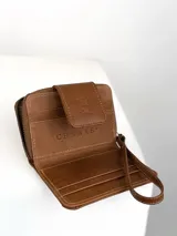 Mini billetera de cuero color marrón con textura combinada, lisa y efecto croco en la solapa. Cuenta con cierre perimetral, múltiples ranuras para tarjetas y una correa de muñeca extraíble.