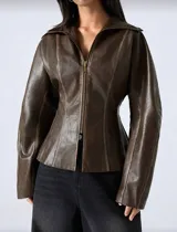 Chaqueta de efecto cuero en color marrón chocolate, con silueta entallada, cierre frontal con cremallera, cuello amplio y mangas con volumen.