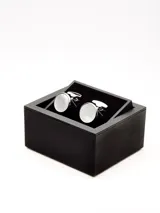 Par de gemelos plateados con centro circular negro.