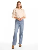 Jean de tiro alto con corte wide leg, confeccionado en denim azul. Presenta cierre frontal con botón, pasadores para cinturón y bolsillos funcionales en la parte delantera y trasera.