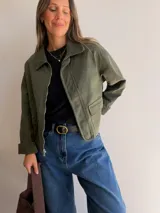 Chaqueta de corte recto color camel, con cierre frontal de cremallera, cuello camisero y puños en tejido de pana a tono. Presenta bolsillos frontales tipo parche y diseño estructurado.