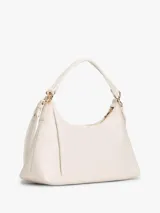 Cartera Tommy Hilfiger de poliuretano color beige, con cierre superior de cremallera, asa corta y correa extraíble. Cuenta con el monograma metálico de la marca en el frente.