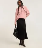 Suéter de punto color crema con cuello redondo y mangas largas ajustadas. Modelo slim alargado con efecto de pelitos.