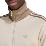 Campera deportiva Adidas modelo Beckenbauer, de color beige con las icónicas tres tiras en tono tostado en las mangas. Presenta cuello alto, cierre frontal completo y bolsillos laterales con cierre.