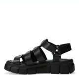 Sandalias de estilo gladiador con plataforma dentada, confeccionadas en cuero negro con tiras entrecruzadas y ajuste mediante velcro en el talón.