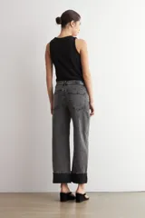 Jean culotte de tiro medio, color gris oscuro, con corte recto y botamanga ancha doblada.