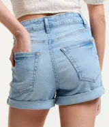 Short de jean celeste, corte hotpants, de cintura alta, con bolsillos delanteros y traseros, cierre con botón y cremallera, y ruedo doblado.