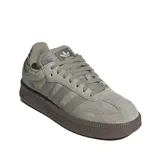 Championes Adidas Samba XLG, color gris claro con suela gruesa de goma marrón oscuro. Presentan un diseño clásico de gamuza con las tres franjas laterales en material sintético y la inscripción "SAMBA" en dorado.