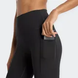 Calza deportiva larga de tiro alto, color negro, con bolsillos laterales en las piernas y tecnología de secado rápido NB DRY.