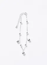 Pulsera de cadena eslabonada de plata 925 con pequeños abalorios esféricos intercalados y dijes colgantes en forma de corazón. Incluye cadena de alargue finalizada con una pequeña placa distintiva.