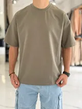 Remera oversize de algodón pesado en color verde militar, con cuello redondo y mangas cortas.