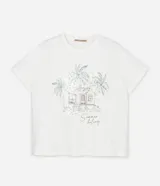 Remera de algodón color blanco, manga corta y cuello redondo, con un estampado lineal de una cabaña tropical rodeada de palmeras y la frase "Summer feeling". Algunas partes del estampado tienen lentejuelas transparentes.